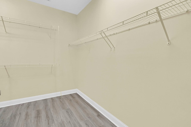 walk in closet featuring hardwood / wood-style floors