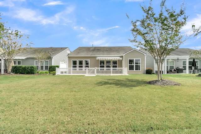 back of house featuring a pergola and a lawn