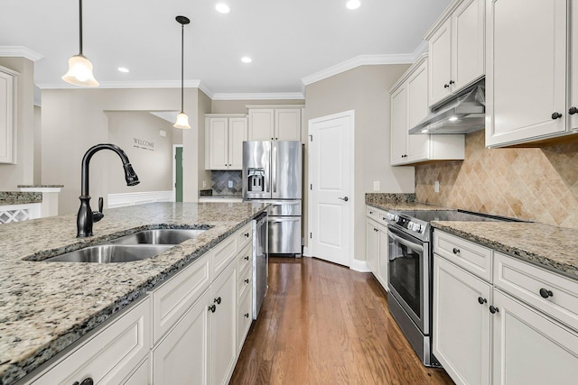 kitchen featuring pendant lighting, white cabinets, appliances with stainless steel finishes, and dark wood-type flooring