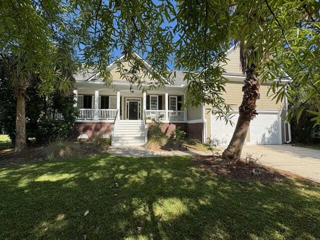 view of front of house with a front lawn, covered porch, brick siding, concrete driveway, and stairway