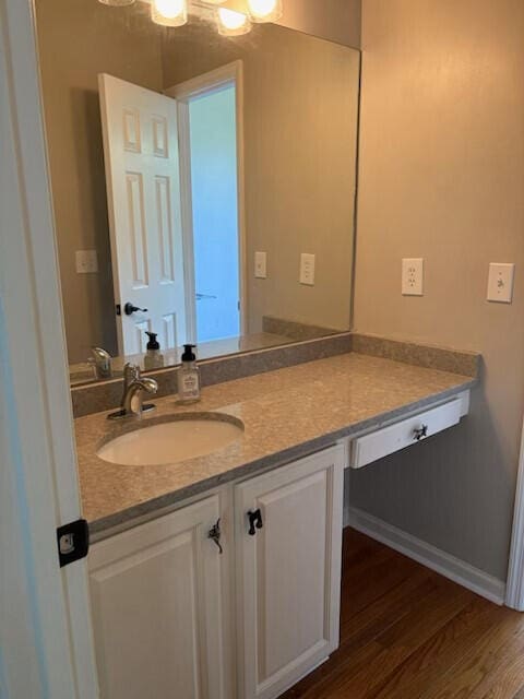 bathroom featuring wood finished floors and vanity