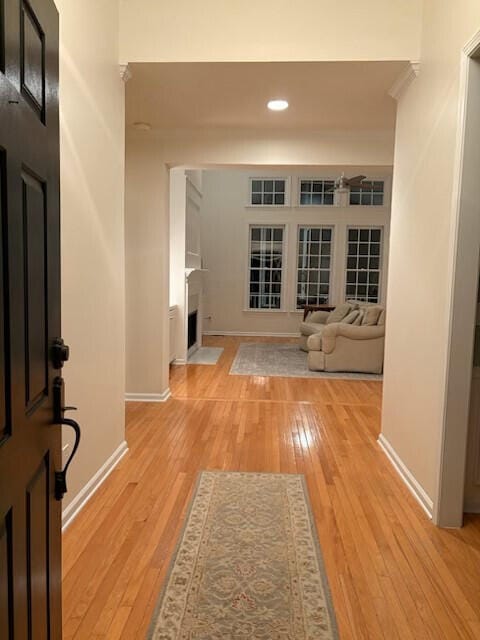 corridor with recessed lighting, baseboards, and light wood finished floors