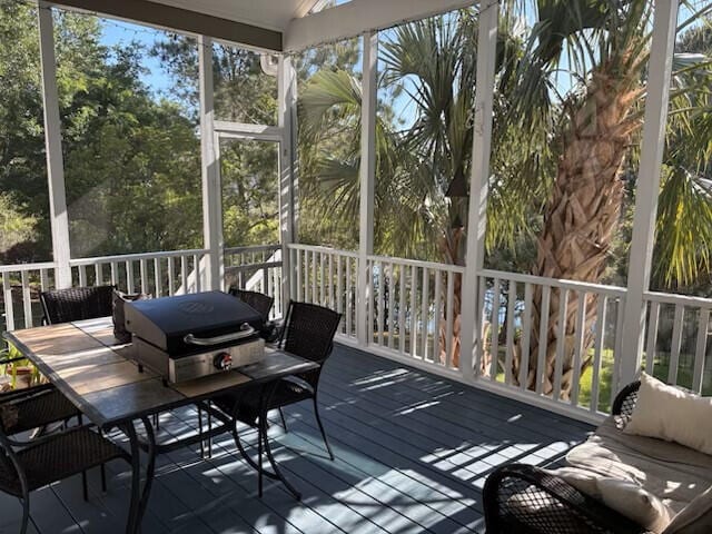 sunroom featuring outdoor dining space