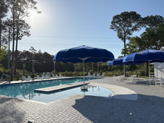pool featuring a patio area and fence
