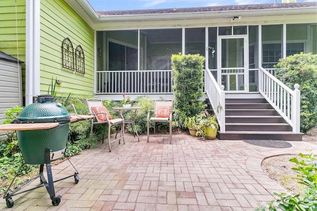 view of patio / terrace with a sunroom and grilling area