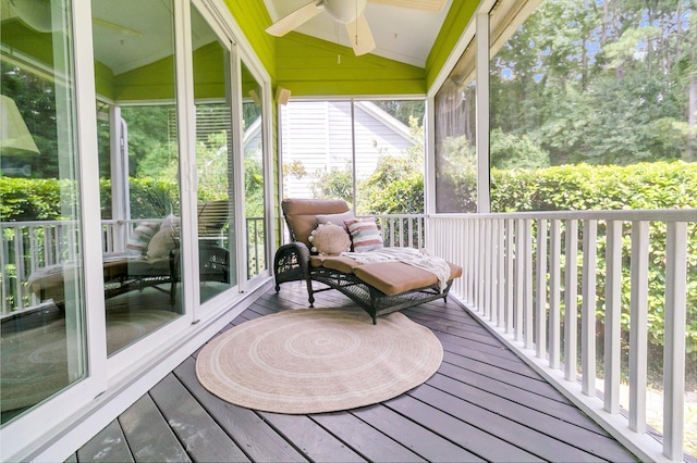 sunroom / solarium with ceiling fan and lofted ceiling