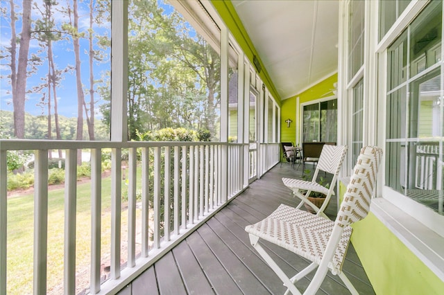 sunroom / solarium featuring lofted ceiling