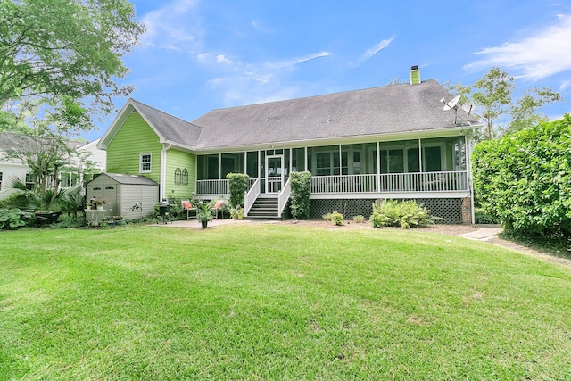 view of front facade featuring a shed, a front lawn, a patio area, and a sunroom