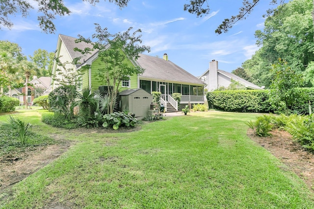 view of yard featuring a sunroom and a shed