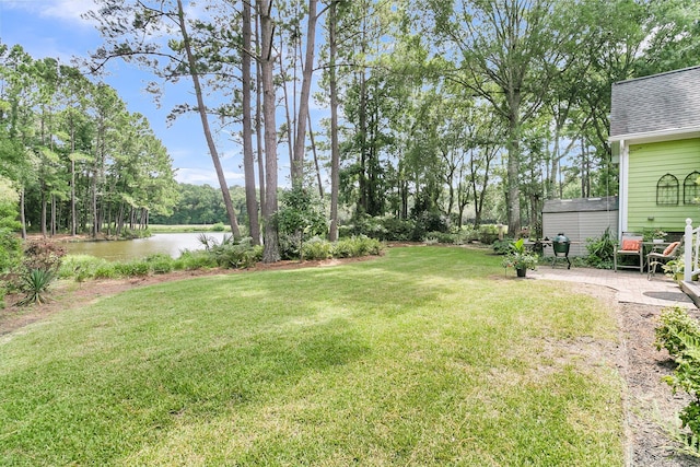 view of yard featuring a patio and a water view