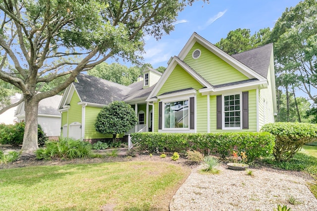 view of front of property featuring a garage and a front yard