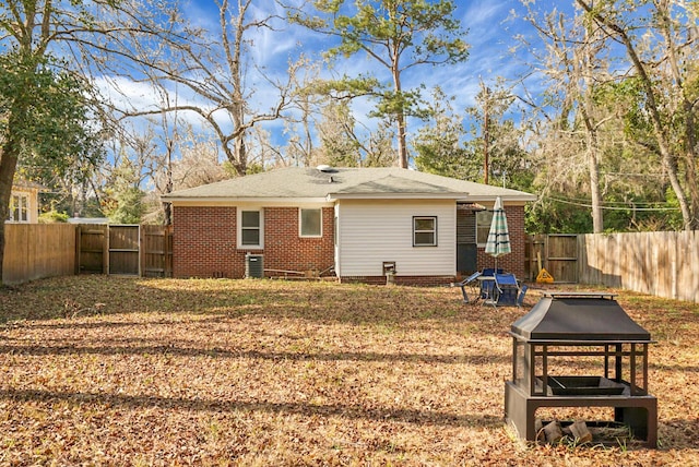 rear view of house with central AC unit