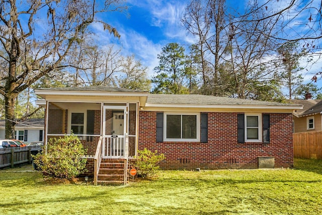 back of house featuring a sunroom and a lawn