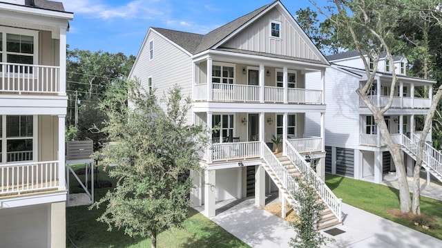 1304 Lieben Rd, Mount Pleasant, SC 29466 - back of house with board and batten siding, stairway, a porch, a balcony, and a garage