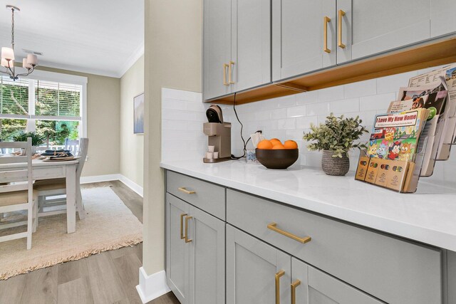 1304 Lieben Rd, Mount Pleasant, SC 29466 - kitchen featuring gray cabinets, a chandelier, wood finished floors, baseboards, and light countertops