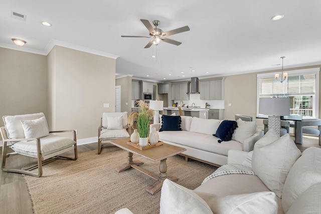 1304 Lieben Rd, Mount Pleasant, SC 29466 - living area featuring crown molding, a chandelier, light wood-style flooring, recessed lighting, and a ceiling fan