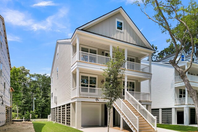1304 Lieben Rd, Mount Pleasant, SC 29466 - rear view of house featuring board and batten siding, a balcony, an attached garage, driveway, and stairs