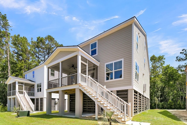 1304 Lieben Rd, Mount Pleasant, SC 29466 - rear view of property with stairway, a sunroom, a ceiling fan, a lawn, and central air condition unit