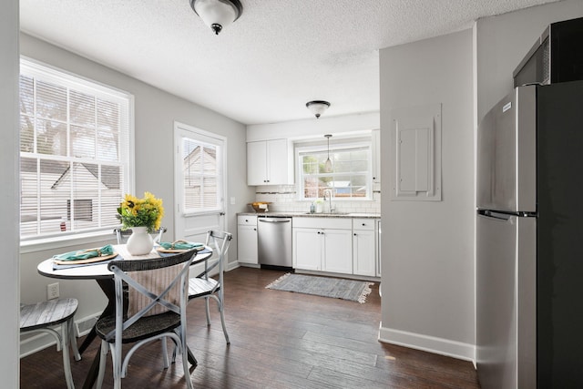 kitchen featuring sink, appliances with stainless steel finishes, white cabinets, and dark hardwood / wood-style floors