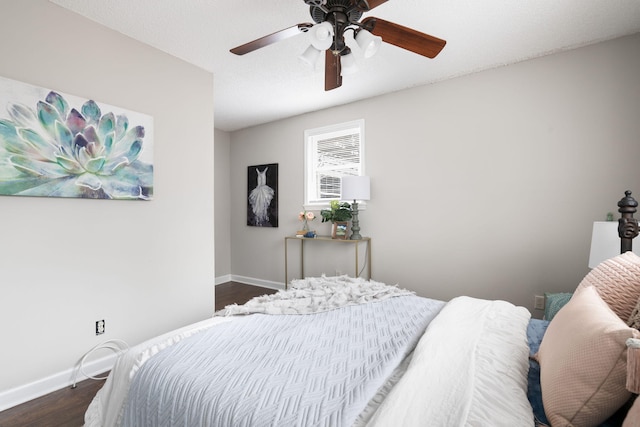 bedroom featuring dark hardwood / wood-style flooring and ceiling fan