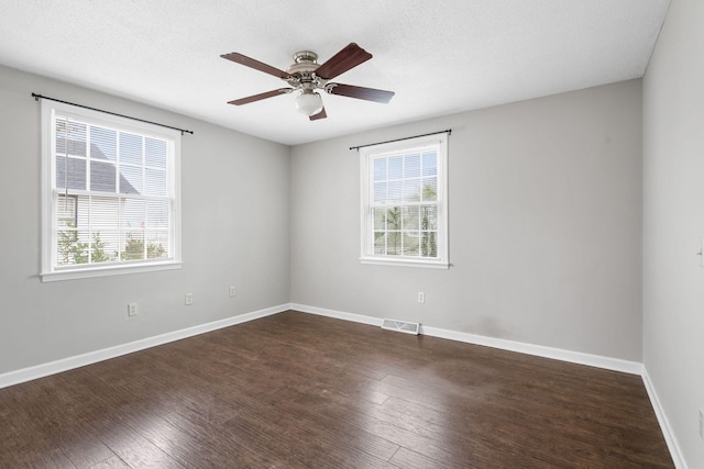 unfurnished room with a healthy amount of sunlight, ceiling fan, and dark hardwood / wood-style floors