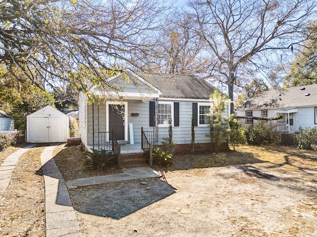 bungalow-style home with a shed