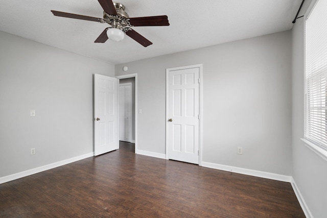 unfurnished bedroom with a closet, dark hardwood / wood-style floors, and ceiling fan