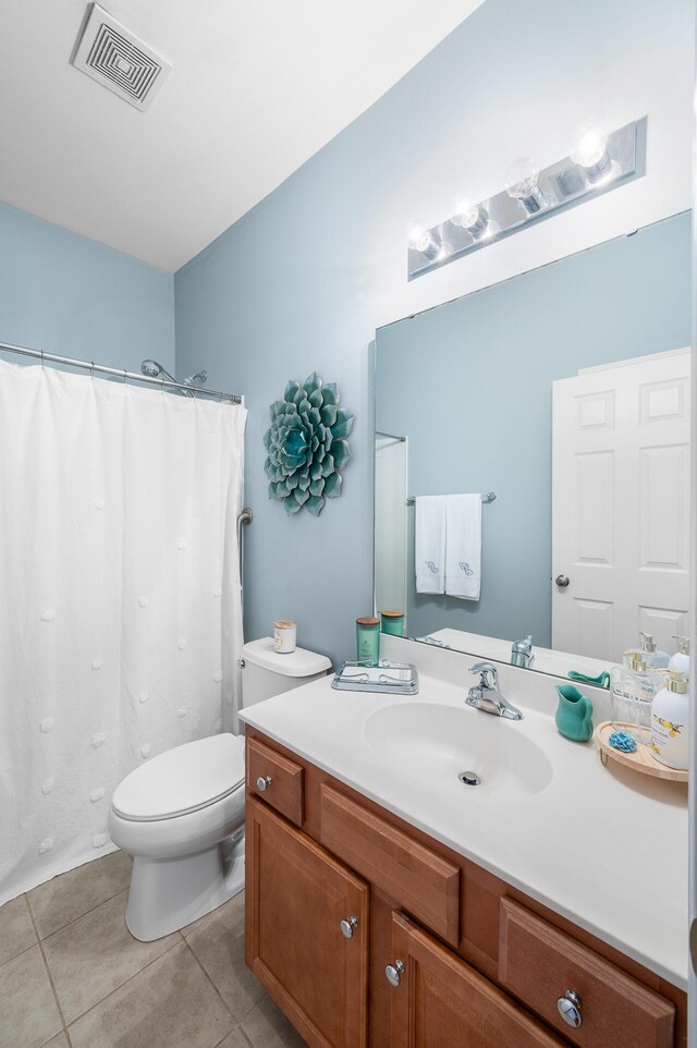 bathroom featuring tile patterned flooring, vanity, toilet, visible vents, and curtained shower