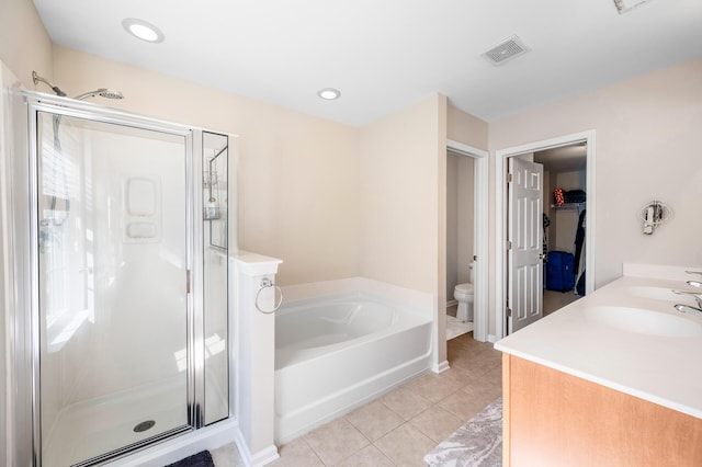 bathroom with visible vents, a shower stall, toilet, a garden tub, and tile patterned flooring