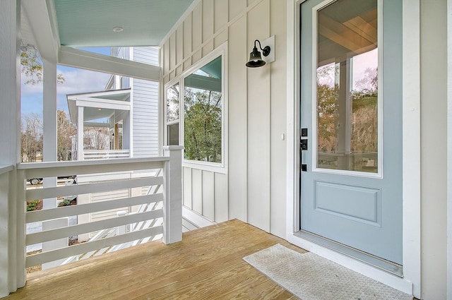 property entrance featuring board and batten siding and a porch