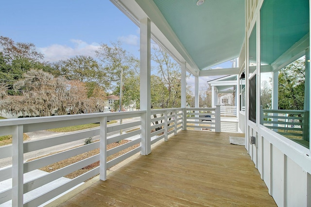 unfurnished sunroom featuring lofted ceiling