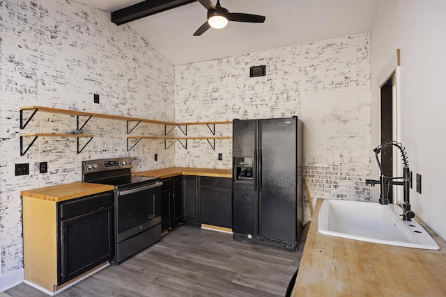 kitchen with stainless steel electric range, sink, beam ceiling, black fridge, and wood counters