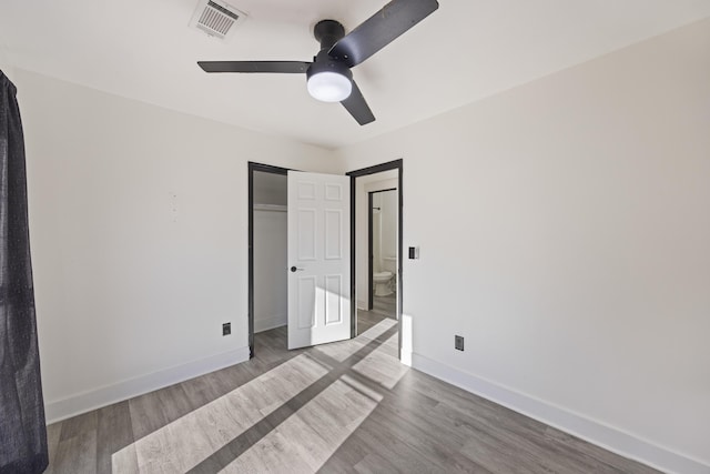 unfurnished bedroom with ceiling fan, wood-type flooring, and a closet