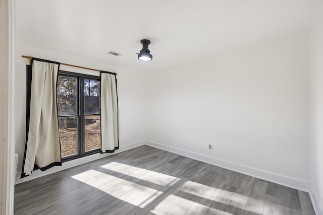 spare room with hardwood / wood-style floors