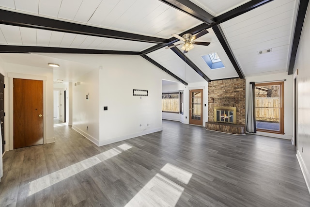 unfurnished living room featuring dark hardwood / wood-style floors, lofted ceiling with skylight, and a fireplace