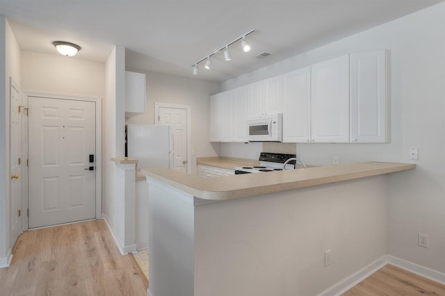 kitchen featuring white cabinetry, kitchen peninsula, light hardwood / wood-style flooring, and white appliances