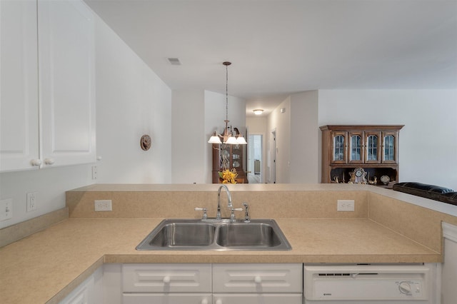 kitchen with white cabinets, hanging light fixtures, dishwashing machine, a chandelier, and sink