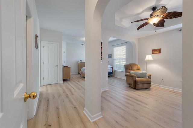 sitting room with ceiling fan and light hardwood / wood-style flooring