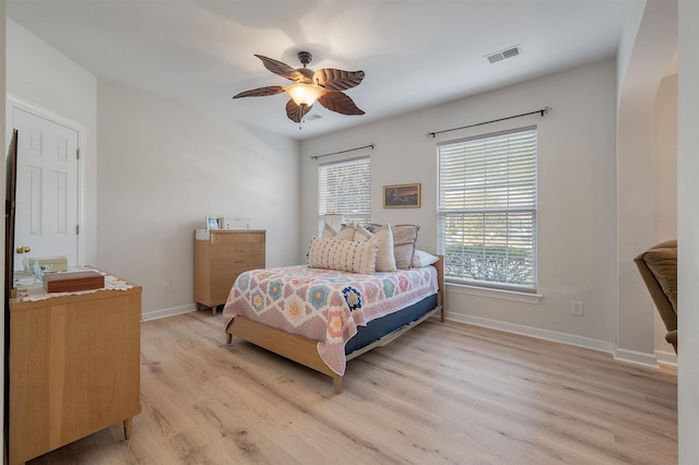 bedroom with light hardwood / wood-style flooring and ceiling fan