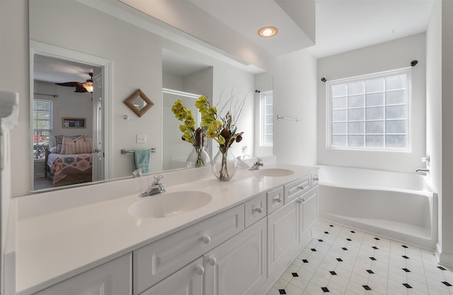 bathroom with vanity, plus walk in shower, and ceiling fan