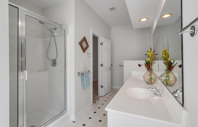 bathroom featuring vanity and an enclosed shower