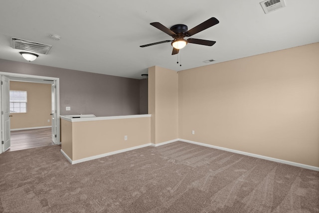 unfurnished room featuring visible vents, baseboards, and carpet