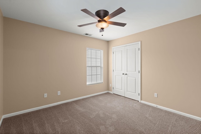 unfurnished bedroom featuring a closet, visible vents, baseboards, and carpet