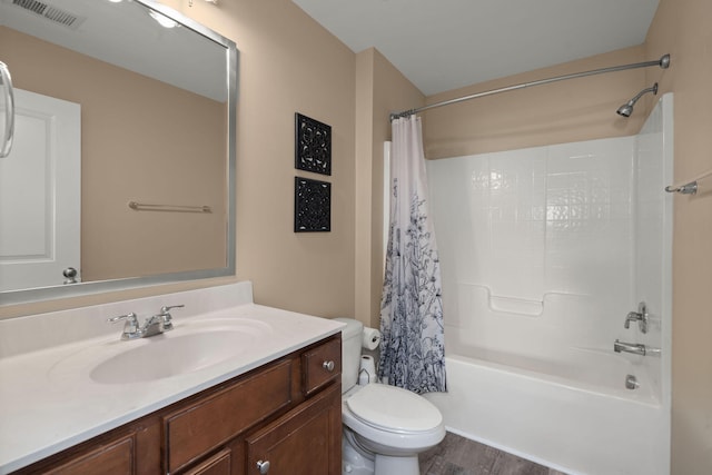 full bath with visible vents, toilet, shower / bath combo, wood finished floors, and vanity