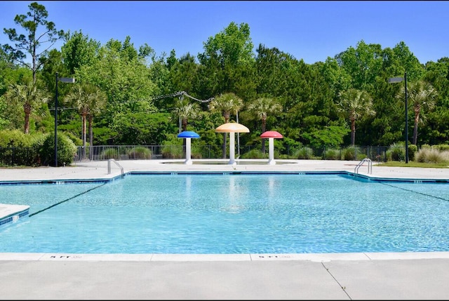 community pool featuring a patio area and fence