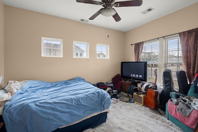 bedroom featuring visible vents, carpet, and a ceiling fan