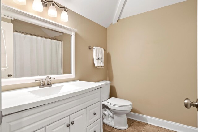 1119 Bruton Blvd, Moncks Corner, SC 29461 - full bath featuring toilet, vanity, vaulted ceiling, baseboards, and tile patterned floors