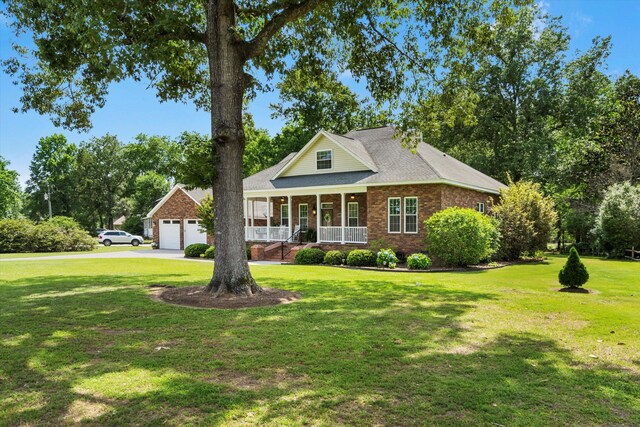 1119 Bruton Blvd, Moncks Corner, SC 29461 - traditional-style home with a porch, brick siding, a front yard, and concrete driveway