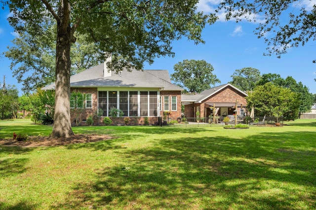 1119 Bruton Blvd, Moncks Corner, SC 29461 - back of property with a sunroom, brick siding, and a chimney