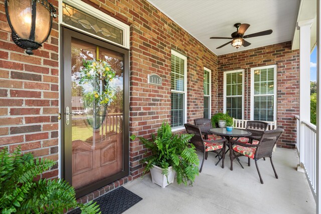 1119 Bruton Blvd, Moncks Corner, SC 29461 - view of exterior entry with a ceiling fan, a porch, and brick siding